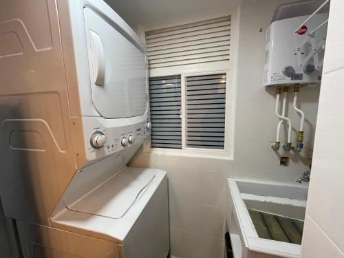 a kitchen with a washer and dryer and a sink at Apartamento en Cali Inn tropical CLO in Cali
