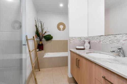 a bathroom with a sink and a shower at Browning Street Sea Drift in Byron Bay