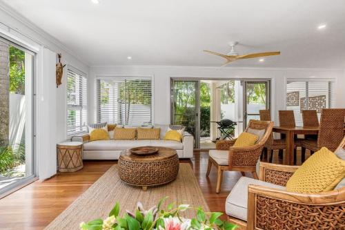 a living room with a couch and a table at Browning Street Sea Drift in Byron Bay