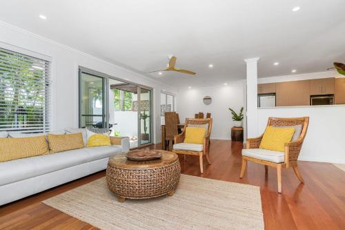 a living room with a couch and chairs and a table at Browning Street Sea Drift in Byron Bay