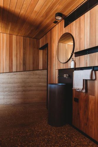a bathroom with a sink and a mirror at Yonder Studio at Basalt Luxury Accommodation in Canobolas