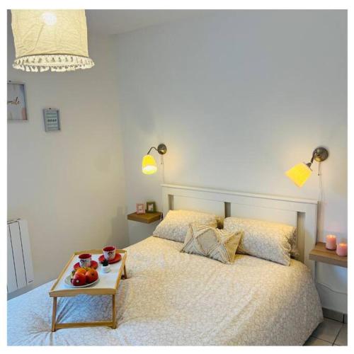 a bedroom with a bed with a tray of fruit on it at Home Sweet Home in Gex