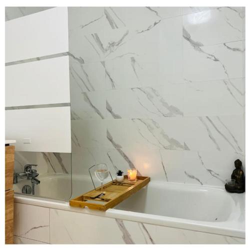a candle sitting on a tray next to a bath tub at Home Sweet Home in Gex