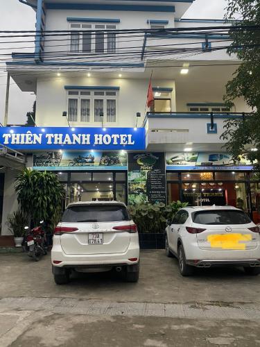 two cars parked in front of a hotel at Thien Thanh Hotel in Phong Nha
