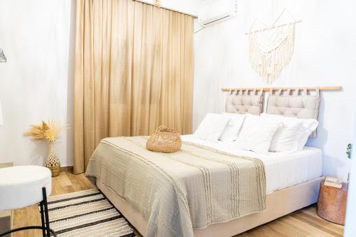 a bedroom with a large white bed with white pillows at MyKosVilla with private pool in Kos Town