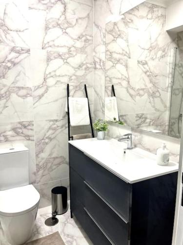 a bathroom with a sink and a toilet at Olympic Apartment in Braga