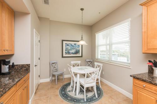 a kitchen with a table and chairs and a window at SouthernVilla Ticket to Paradise in Palm Coast
