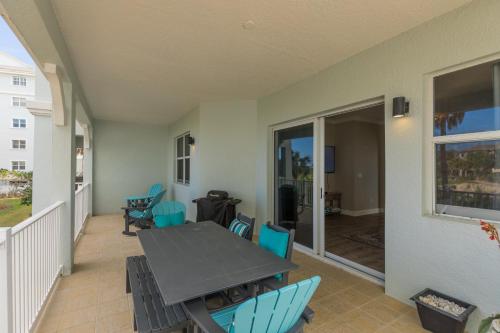 a patio with a table and chairs on a balcony at SouthernVilla Ticket to Paradise in Palm Coast