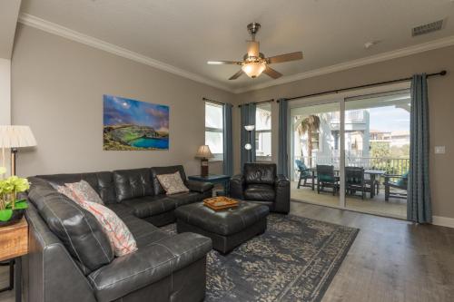 a living room with a leather couch and chairs at SouthernVilla Ticket to Paradise in Palm Coast