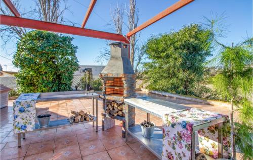 a patio with a brick fireplace on a roof at 4 Bedroom Beautiful Home In Lorca in Lorca