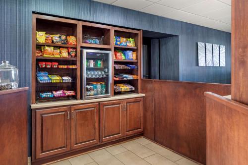 a restaurant with a refrigerator with lots of food at Best Western Plus Madison-Huntsville Hotel in Madison
