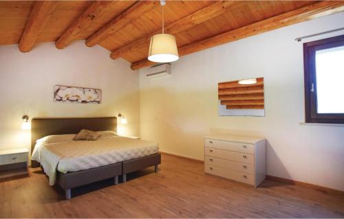 a bedroom with a bed and a wooden ceiling at Oriental Muti in Chiaramonte Gulfi