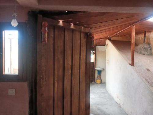 a hallway in a house with a wood wall at Auberge des lacs in Imilchil