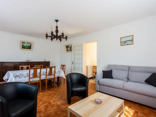 a living room with a couch and a table at Basque style house 15 min from Bidart beaches in Arcangues