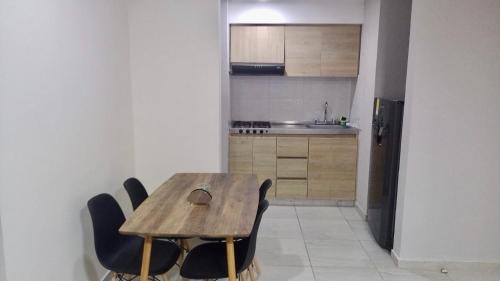 cocina con mesa de madera y sillas en Apartamento Amoblado en Barranquilla, en Barranquilla