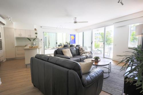 a living room with a couch and a table at The Cove Noosa - Apartment 4 in Noosa Heads