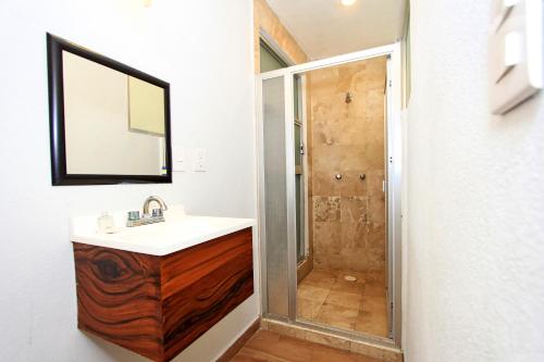 a bathroom with a sink and a shower at Hotel Grand Guanajuato in Guanajuato