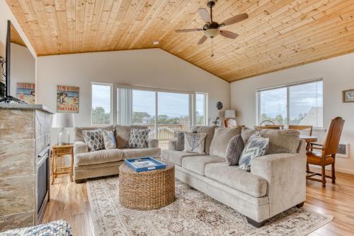 a living room with a couch and a ceiling fan at Riveredge Retreat in Seaside