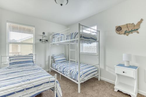 a bedroom with two beds and a bunk bed at Riveredge Retreat in Seaside