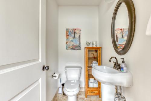 a white bathroom with a sink and a mirror at Riveredge Retreat in Seaside