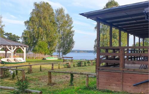 a wooden pavilion with a gazebo and a lake at 2 Bedroom Cozy Home In Biskupiec in Biskupiec