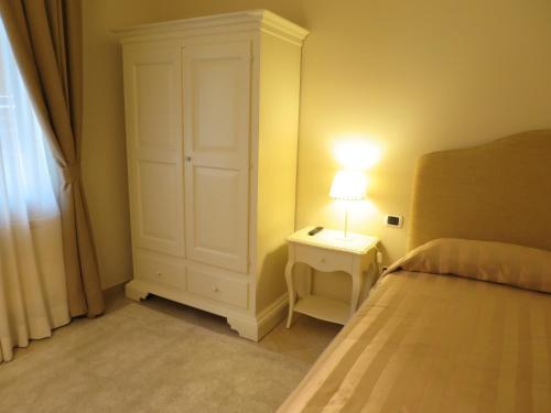 a bedroom with a bed and a night stand with a lamp at Residenza Marchesi Pontenani in Florence
