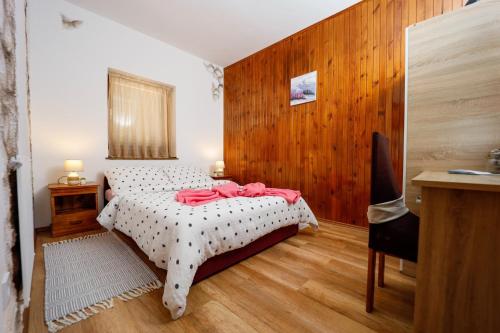 a bedroom with a bed and a wooden wall at Family friendly house with a parking space Jastrebarsko, Prigorje - 20705 in Jastrebarsko