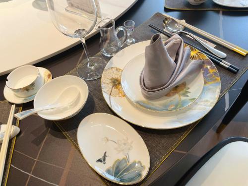 a table with plates and silverware on it at F·World Convention Center in Wuhan
