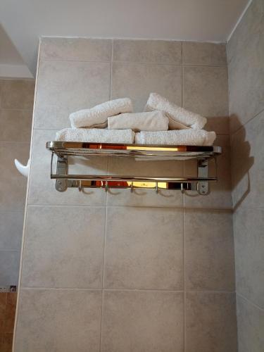 a bathroom with two towels on a wall at Hostal Virgen del Rosario Cafayate in Cafayate