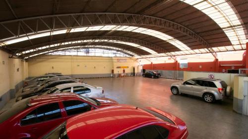a parking lot with rows of cars in a garage at Hotel El Conde Naucalpan Only Adults in Mexico City