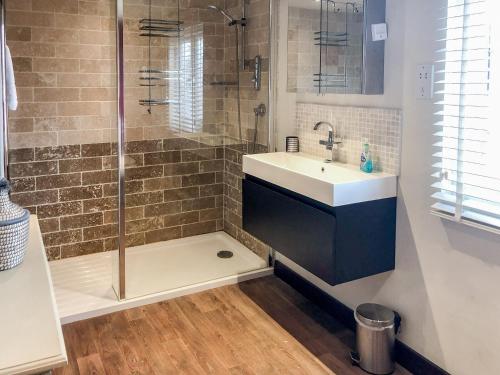 a bathroom with a sink and a shower at Beehive Cottage in Wittersham