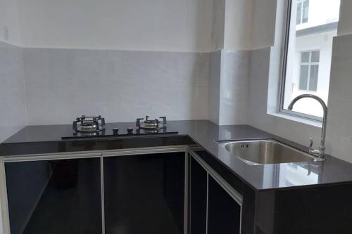 a kitchen with a sink and a sink at Desaru Nova Guest House with BBQ and Near Tanjung Balau Beach in Bandar Penawar