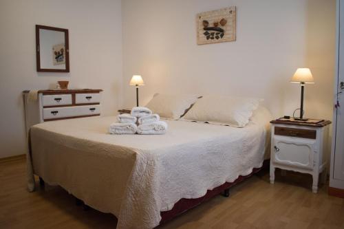 a bedroom with a bed with towels on it at Hostal Virgen del Rosario Cafayate in Cafayate