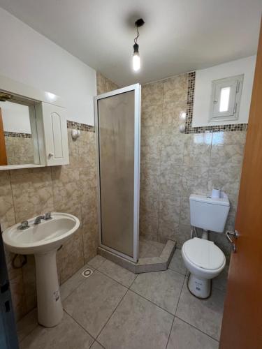 a bathroom with a shower and a toilet and a sink at Alojamiento ruta 3 in Trelew