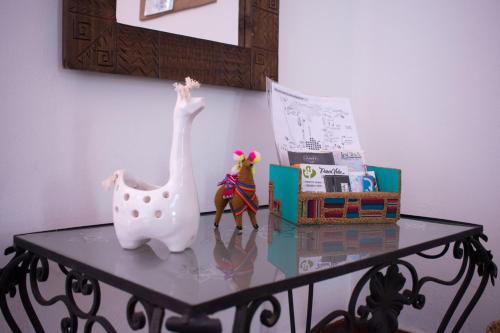 a table with a toy horse and books on it at Hostal Virgen del Rosario Cafayate in Cafayate