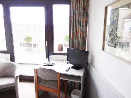 a room with a desk with a computer on it at Zentral Hotel Poststuben in Krefeld