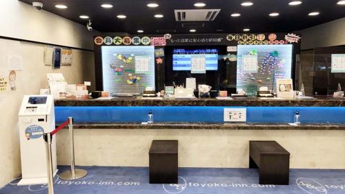 a restaurant with a blue counter with two stools at Toyoko Inn Matsudo eki Higashi guchi in Matsudo