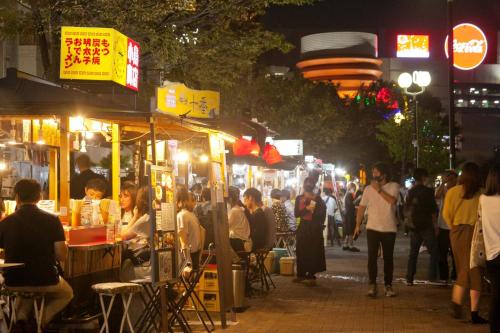 a crowd of people walking around a market at night at Reisenkaku Hotel Kawabata in Fukuoka