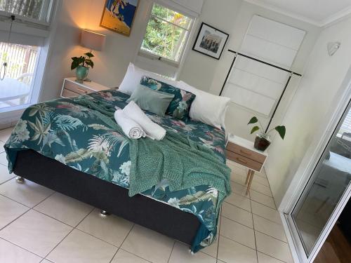 a bedroom with a large bed with a blue comforter at Clearwater estate in Doonan