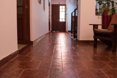a hallway with a tile floor and a door at Hostal Virgen del Rosario Cafayate in Cafayate
