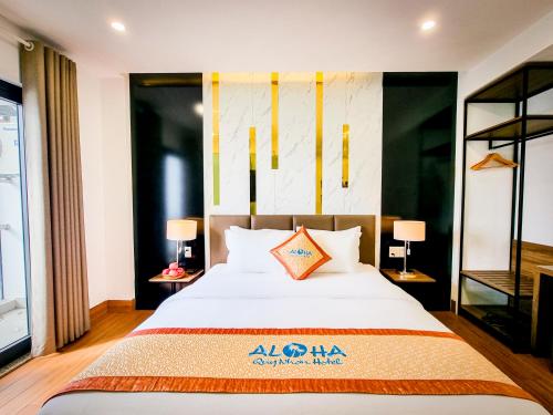 a bedroom with a large bed and two lamps at Aloha Hotel Quy Nhơn in Quy Nhon
