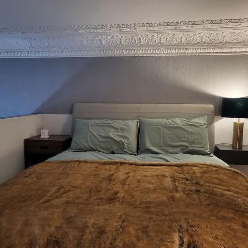 a bedroom with a large bed with a white headboard at 5 Luxury Spacious Loft - Prime Location - Comfortable Bed & Sofa in Brighton & Hove