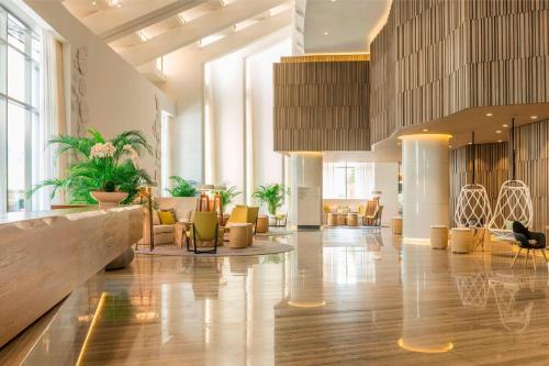 a lobby with couches and chairs in a building at Le Royal Meridien Beach Resort & Spa Dubai in Dubai