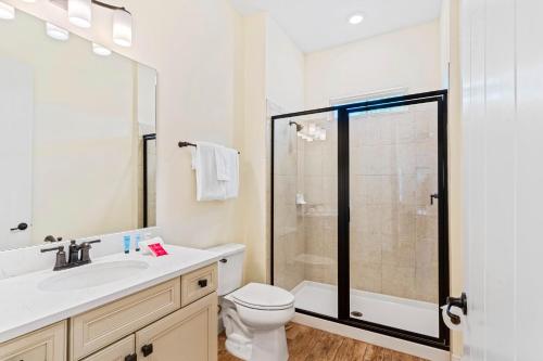 a bathroom with a toilet sink and a shower at 3000 Latitude Lane in Orlando