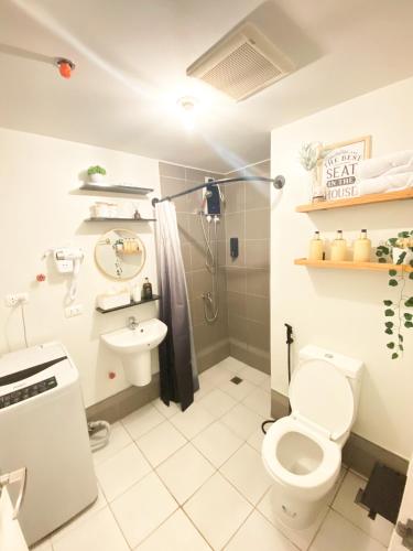 a bathroom with a toilet and a sink at Fully furnished condo in Quezon City in Manila