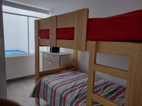 a bedroom with two bunk beds and a window at J&B Aparment 1 Punta Hermosa in Punta Hermosa