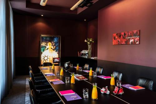 a dining room with a long table and chairs at Le Méridien Vienna in Vienna