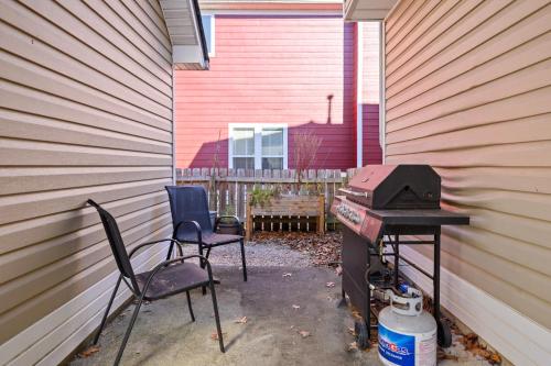 a patio with two chairs and a grill next to a house at Spacious Serene 3BR Near LakePoint & DT Acworth in Acworth