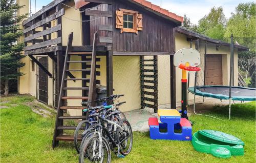 a house with bikes parked outside of it with a playground at Beautiful Home In Krzynia With Wifi in Krzynia