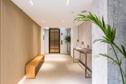 a hallway with a wooden bench in a house at Urbanwood Ap Lei Chau in Hong Kong